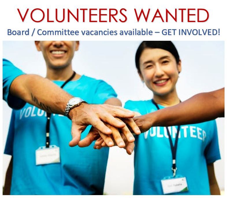 A group of people put their arms in a circle to show camaraderie 