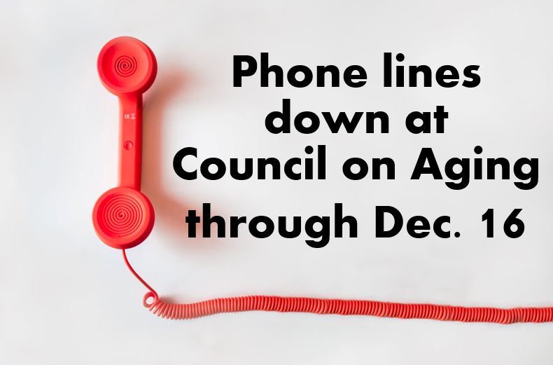 A pink phone receiver is in the left third of the photo with its curly phone line stretching across 